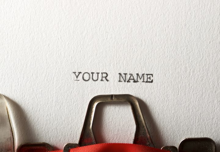 The sentence, your name, written with a typewriter.